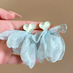 Detail of light green heart studs with sky blue organza bow tassel earrings