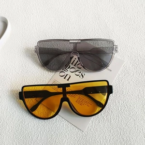 Fashionable oversized semi-rimless sunglasses in tawny and yellow colors on art card