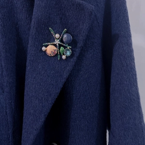 Ocean theme enamel starfish brooch with shells and pearls on blue wool coat lapel
