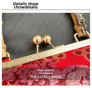 Detail of red brocade evening bag with gold metal frame and bamboo-style handle