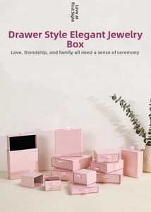 Pink drawer jewelry box set with ribbon handles and black foam inserts for accessories