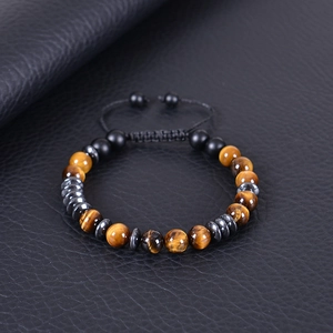 Morse code bracelet with tiger eye beads and hematite stones on black leather background
