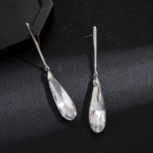 Elegant drop earrings featuring long silver metal bars and faceted crystal teardrop pendants