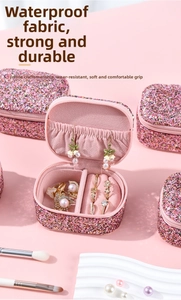 Detail of pink glitter jewelry box with velvet interior slots for rings and earrings