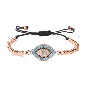 Detail of 18K gold plated Evil Eye bracelet featuring blue zirconia and polished metal beads