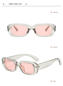 Detail view of grey transparent rectangular sunglasses with pink lenses and side specs
