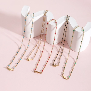 Colorful beaded Ankh necklaces in stainless steel and gold plating shown on display