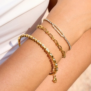 Three-piece gold heart zircon bracelet set featuring star charms and tennis chain style