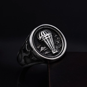 Macro view of vintage stainless steel ring featuring parachute relief and rock texture