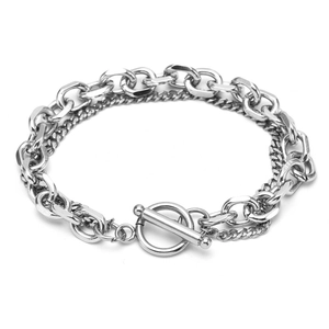 Detail of silver double-layered cuban and twisted chain bracelet with toggle clasp