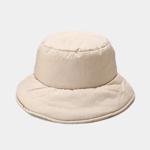 Close-up of beige quilted down fisherman hat with windproof fabric and warm padding