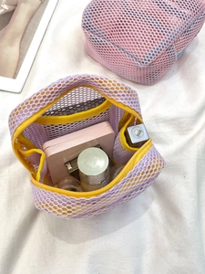 Purple and yellow mesh mini makeup bag for lipstick and cosmetics storage in a home setting