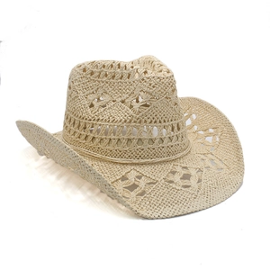 Detail of hollow-out breathable straw cowboy hat with wide brim and intricate pattern