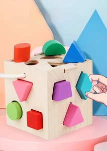 Detail of colorful wooden shape sorter blocks with natural wood intelligence box