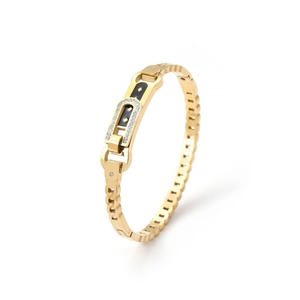Elegant gold hollow butterfly bangle with black enamel and zircons on white background