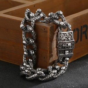Close-up of gothic skull link bracelet in vintage oxidized steel on a wooden box