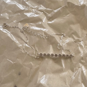 Detail of S925 sterling silver bracelet featuring a row of nine sparkling zircon stones