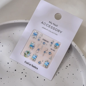 Detailed view of DIY ocean style nail art stickers with pearls and seashell elements