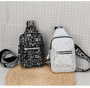 Detail of trendy crossbody chest bags with letter heart print and canvas strap