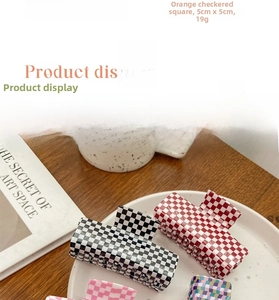 Detail of pink and orange checkered acetate hair claws with precise size and weight specs