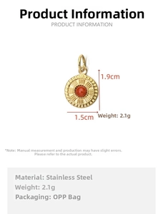 Detail view of a gold-plated stainless steel sunburst pendant with a red center stone