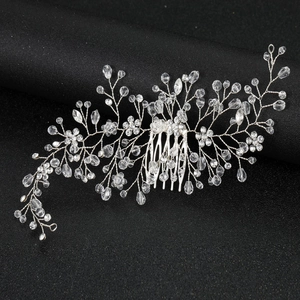 Handmade bridal hair comb with silver wire and sparkling crystal beads on black background