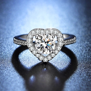 Macro detail of heart-shaped halo engagement ring with one carat round cut moissanite