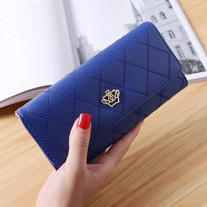 Detailed view of long blue quilted PU leather wallet with a golden crown buckle closure