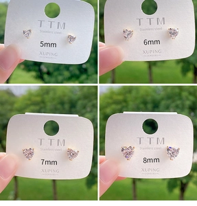Detail view of heart-shaped stainless steel earrings in 5mm to 8mm sizes with clear zircons