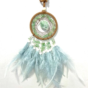 Detail of dream catcher with green crystal stone, light blue feathers and brown leather