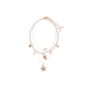 Multilayer ocean necklace with starfish, seashell pendants and white pearls on gold chain