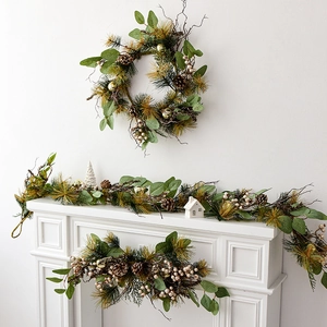 Christmas garland and wreath set with green leaves, golden baubles and pine cones