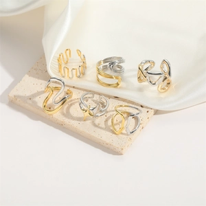 Detailed set of six abstract geometric rings in polished gold and silver finishes
