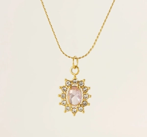 Close-up of a sunburst pendant necklace with a pink oval zircon and 18K gold chain