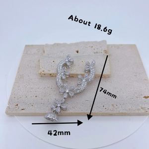 Silver flower pendant with clear zircons, 74mm by 42mm, weighing 18.6g on stone tiles