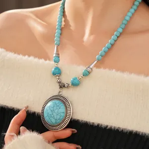 Ethnic bohemian turquoise beaded necklace with large vintage silver-framed pendant
