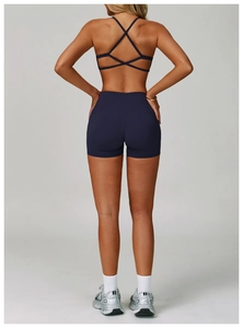 Detail view of navy yoga set showing back cross-strap bra and high-waist shorts