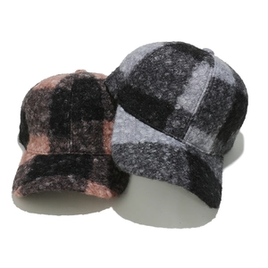 Detail of winter baseball caps showing thick plaid wool texture and lamb wool fabric