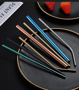 Macro shot of colorful 304 stainless steel straight and curved straws on a black plate