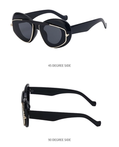 Cat eye sunglasses featuring black frames and gold metal trim shown from side angles