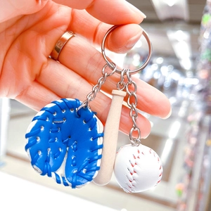 Detailed shot of a 3-in-1 baseball keychain with blue glove, wood bat and white ball