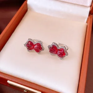 Sparkling zircon bow clip-on earrings with red gemstone resin in a luxury jewelry box