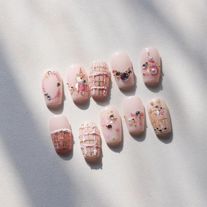 Pink Christmas press-on nails with 3D plaid, bear patterns, and rhinestone accents