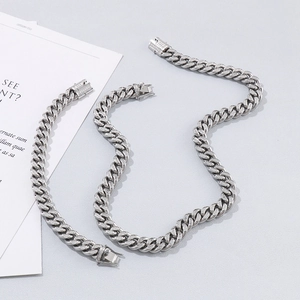 Macro detail of silver Cuban link necklace and bracelet set with micro-paved zircons
