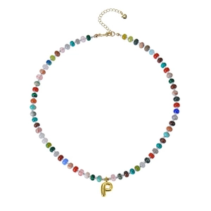 Close-up of bohemian colorful beaded necklace with golden bubble letter P pendant