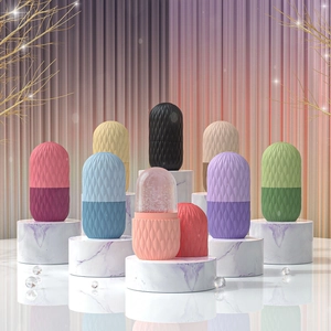 Diamond-textured facial ice rollers in multiple colors displayed on marble