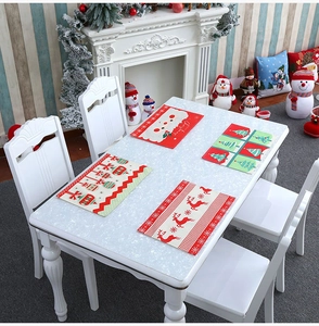 Detailed view of four Christmas placemats with deer, snowmen and holiday tree patterns