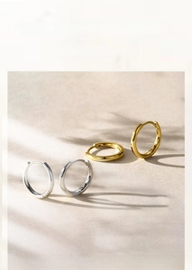 Macro detail of S925 sterling silver hoop earrings with polished finish and hallmarking