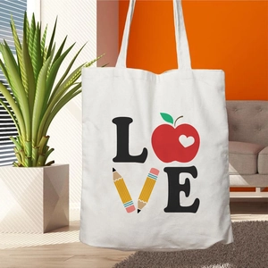 White canvas tote bag with Teacher Life LOVE print featuring apple and pencil icons