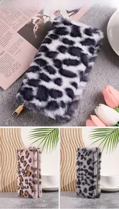 Close-up of leopard print faux fur wallet featuring thick plush texture and metal zipper